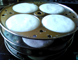 Fermented batter in idli stand, ready to steam